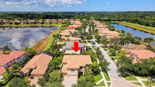 birds eye view of property with a water view