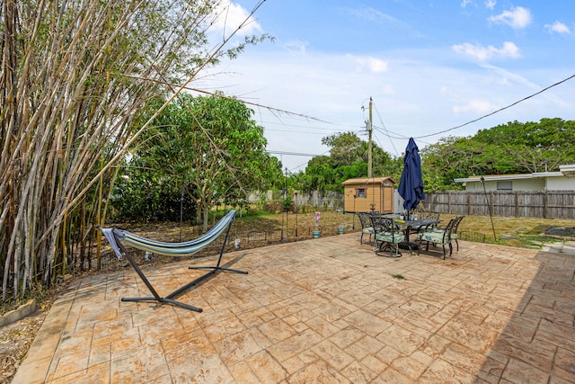 view of patio with a storage unit