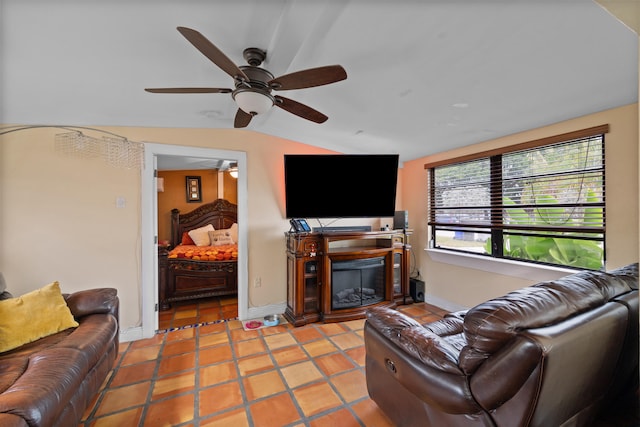 tiled living room with ceiling fan and vaulted ceiling