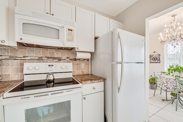 kitchen featuring white appliances, tasteful backsplash, white cabinetry, and an inviting chandelier