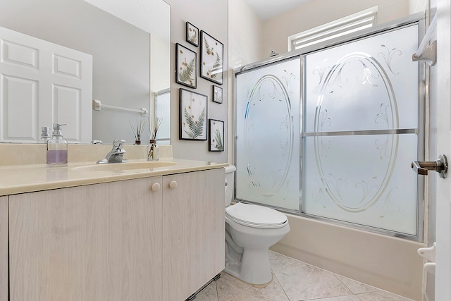 full bathroom with vanity, tile patterned flooring, shower / bath combination with glass door, and toilet