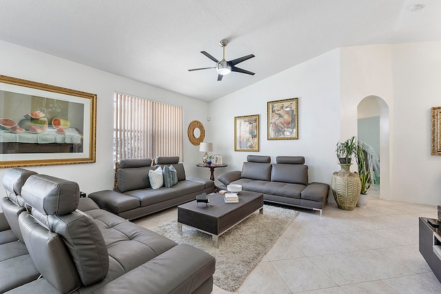 tiled living room featuring lofted ceiling and ceiling fan