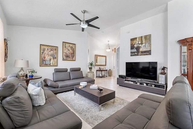 living room with light tile patterned floors, high vaulted ceiling, and ceiling fan