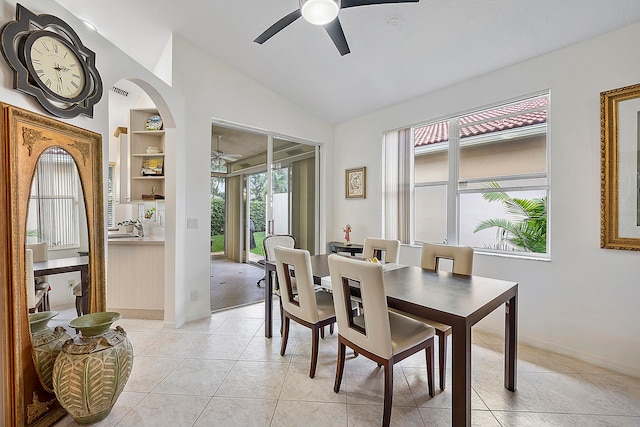 tiled dining area featuring ceiling fan and vaulted ceiling