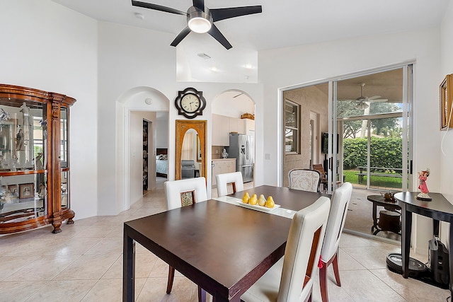 dining room with light tile patterned floors, ceiling fan, and high vaulted ceiling