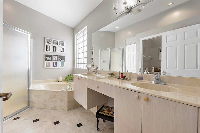 bathroom featuring independent shower and bath, tile patterned floors, lofted ceiling, and dual bowl vanity