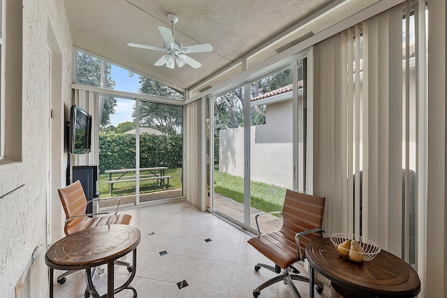 sunroom with ceiling fan and lofted ceiling