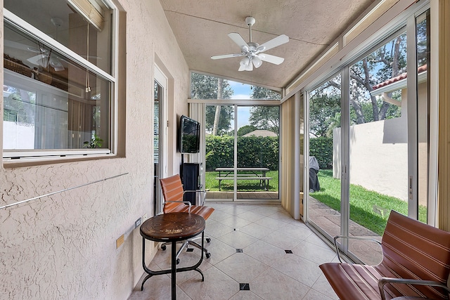 sunroom featuring plenty of natural light, ceiling fan, and lofted ceiling