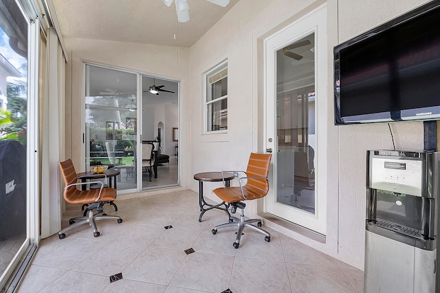 sunroom featuring ceiling fan and vaulted ceiling