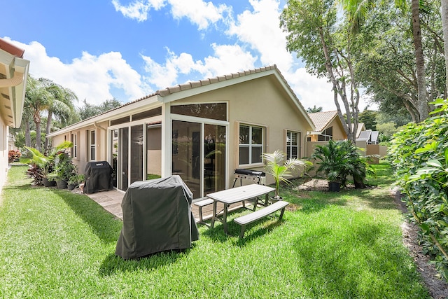 back of house with a lawn