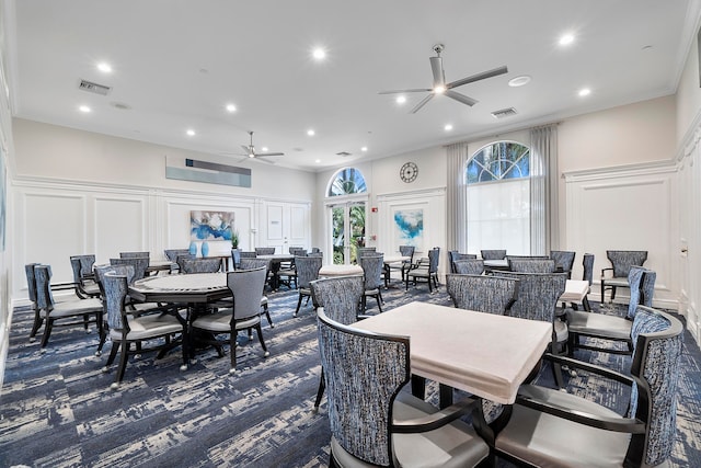 dining room featuring crown molding and ceiling fan