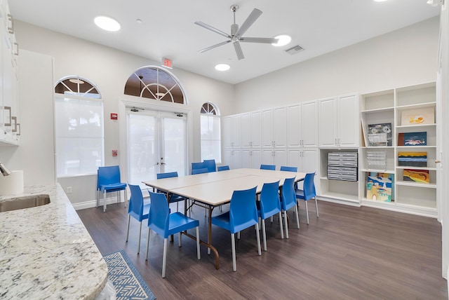 dining space featuring sink, ceiling fan, french doors, and dark wood-type flooring