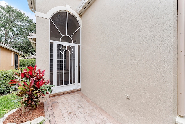 view of exterior entry with a wall mounted air conditioner