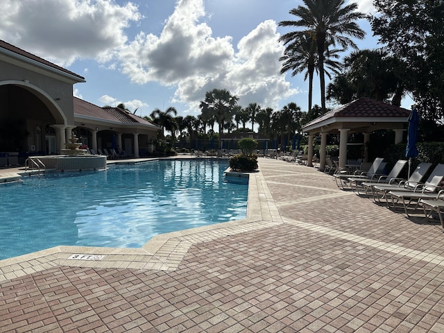 view of swimming pool featuring a patio area and a gazebo