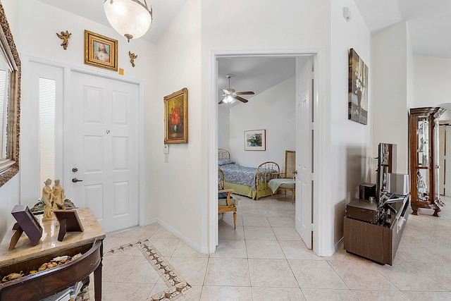 tiled foyer entrance with high vaulted ceiling and ceiling fan