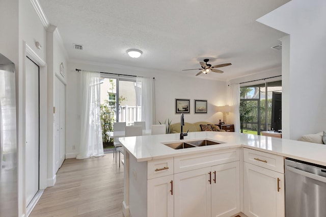 kitchen with ceiling fan, white cabinets, sink, dishwasher, and light hardwood / wood-style floors