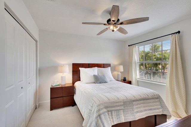 carpeted bedroom with a closet and ceiling fan