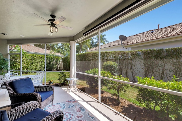 sunroom featuring ceiling fan and a wealth of natural light