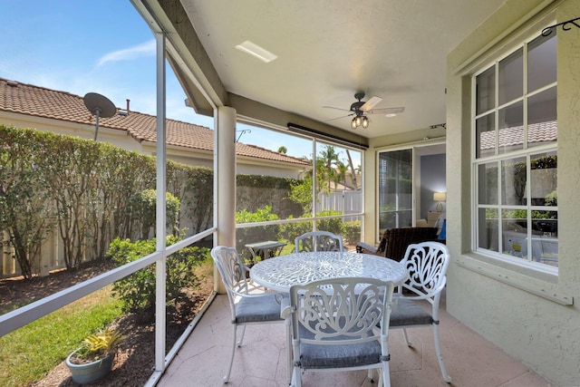 sunroom featuring ceiling fan