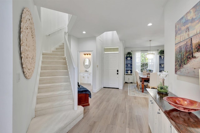 foyer entrance featuring light hardwood / wood-style flooring and sink