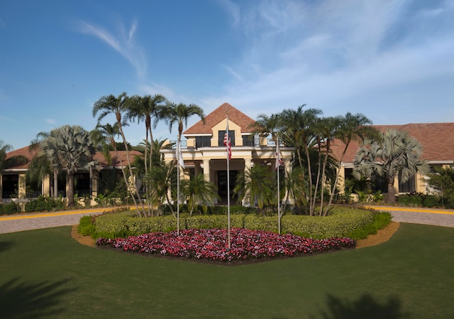 view of property's community with a lawn