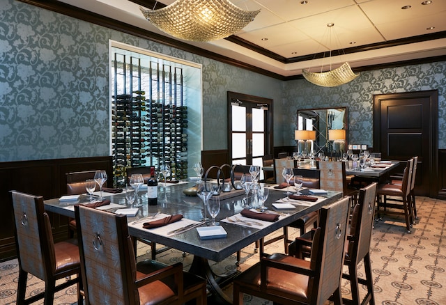 dining room with plenty of natural light, a raised ceiling, and ornamental molding