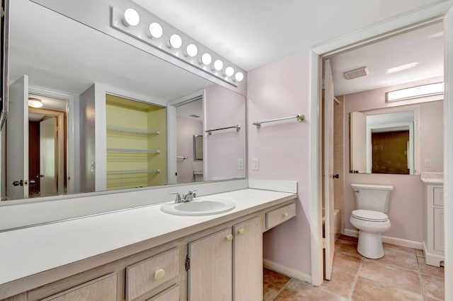 bathroom with oversized vanity, tile floors, and toilet