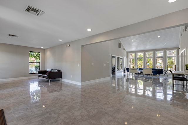 living room featuring french doors, light tile floors, and lofted ceiling