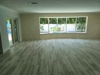 empty room featuring dark hardwood / wood-style flooring and crown molding