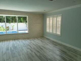 unfurnished room featuring a wealth of natural light, ornamental molding, and wood-type flooring