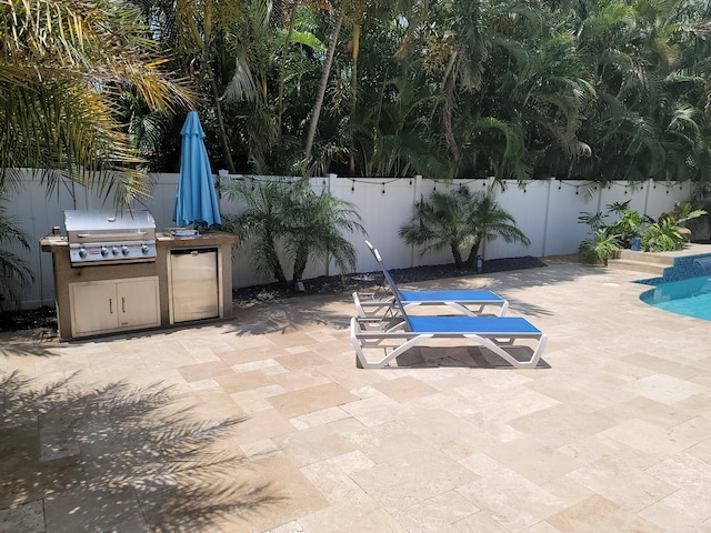 view of patio featuring area for grilling and a grill