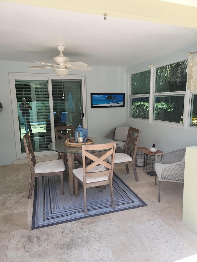 tiled dining space with ceiling fan