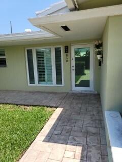 property entrance featuring a patio