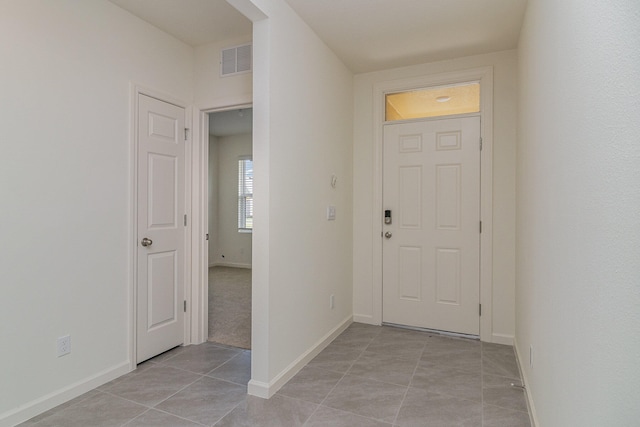 entryway with light tile patterned flooring