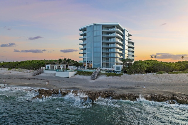 outdoor building at dusk featuring a water view