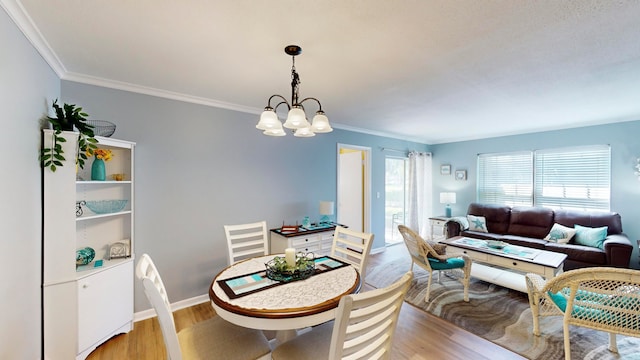 dining space with a notable chandelier, wood-type flooring, and crown molding