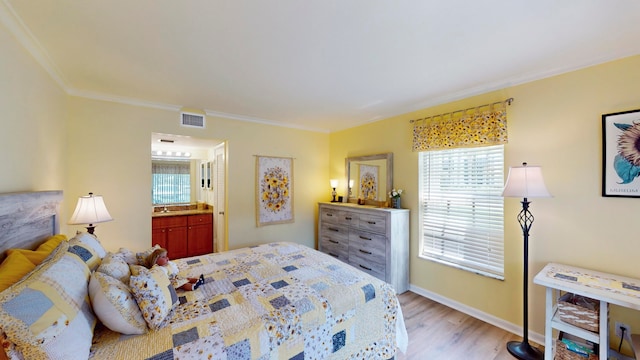 bedroom featuring crown molding, wood-type flooring, and connected bathroom