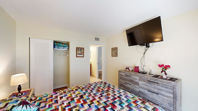 bedroom with wood-type flooring and a closet