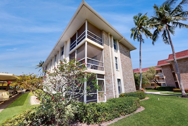 view of side of property with a lawn