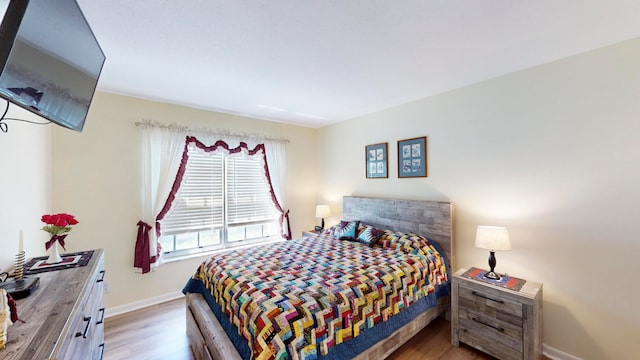 bedroom with hardwood / wood-style floors