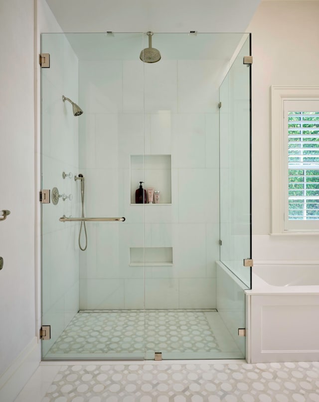 bathroom with a shower with shower door and tile flooring