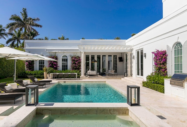 view of pool featuring a patio, grilling area, exterior kitchen, and a pergola