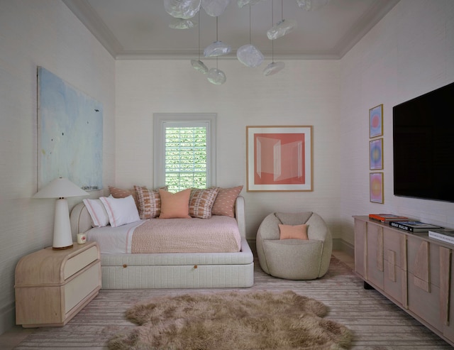 bedroom featuring light hardwood / wood-style floors and crown molding