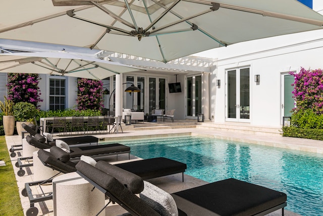 view of pool with french doors and a patio