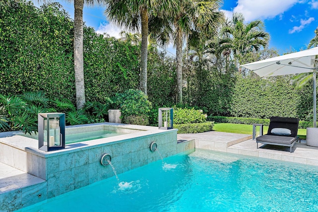 view of pool with pool water feature, an in ground hot tub, and a patio