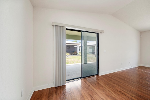 unfurnished room featuring hardwood / wood-style flooring and lofted ceiling