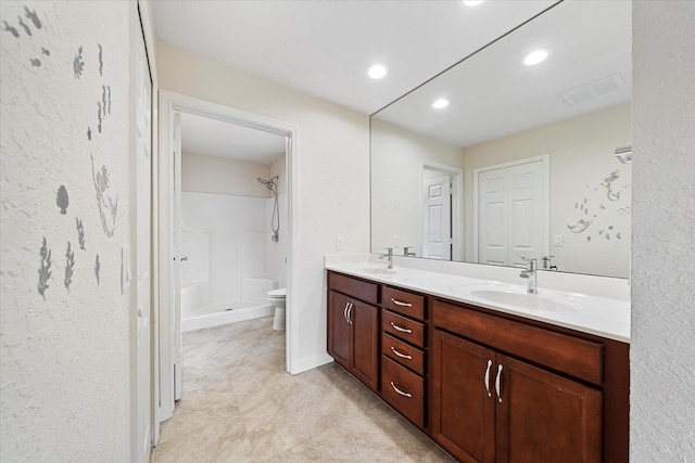 bathroom featuring dual vanity, walk in shower, toilet, and tile floors