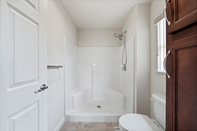 bathroom with walk in shower and toilet