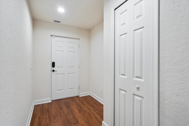 doorway featuring dark wood-type flooring