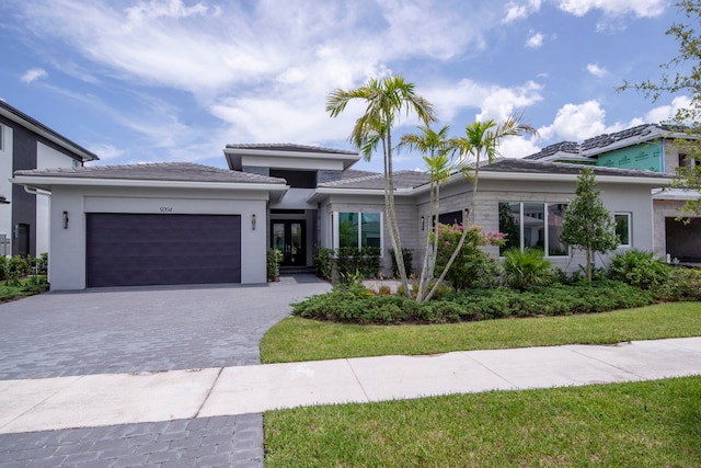 view of front of home with a front yard and a garage